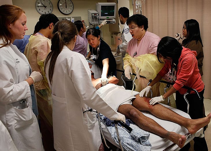  Staff in the Trauma Unit at the John H. Stroger Jr. Cook County Hospital treat a man with a gunshot wound.