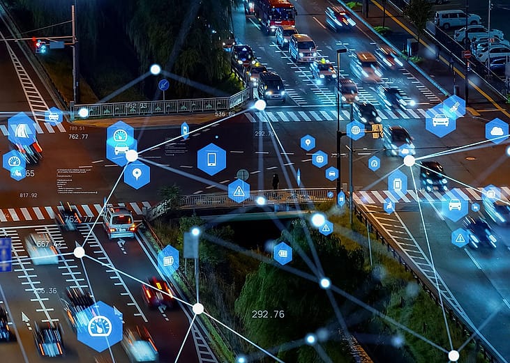 Cars on road during nighttime illustrated with tracking technologies.