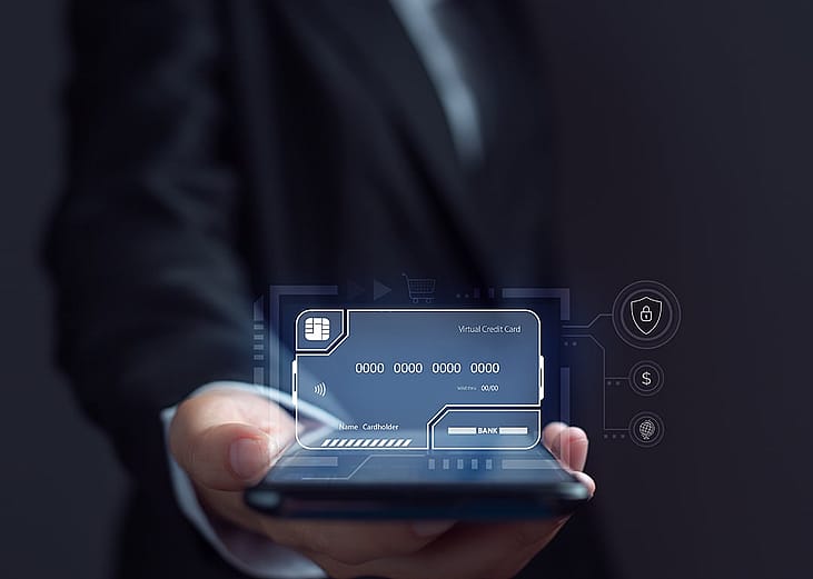 Businessman using an electronic credit card illustrated as a virtual screen.