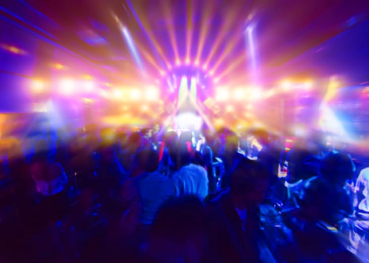 Concert crowd in front of bright stage lights.
