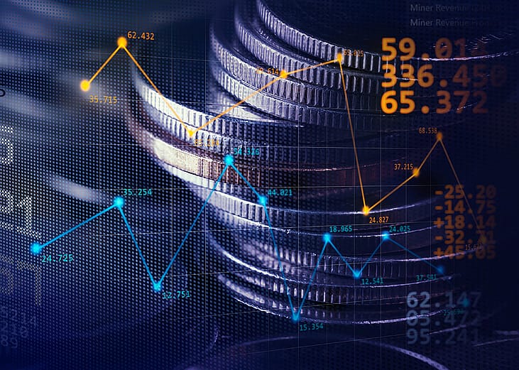 Stack of coins illustrated with stock exchange graphics.