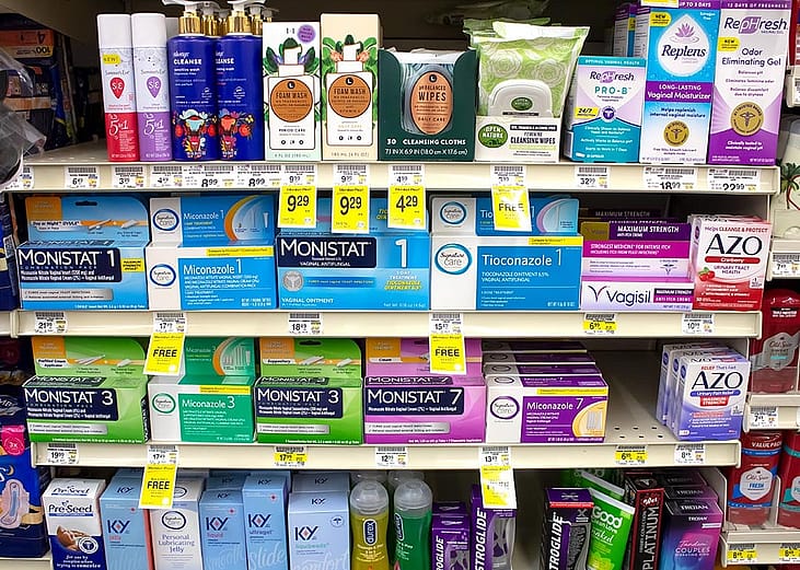 A view of several shelves dedicated to yeast infection products in a drugstore.