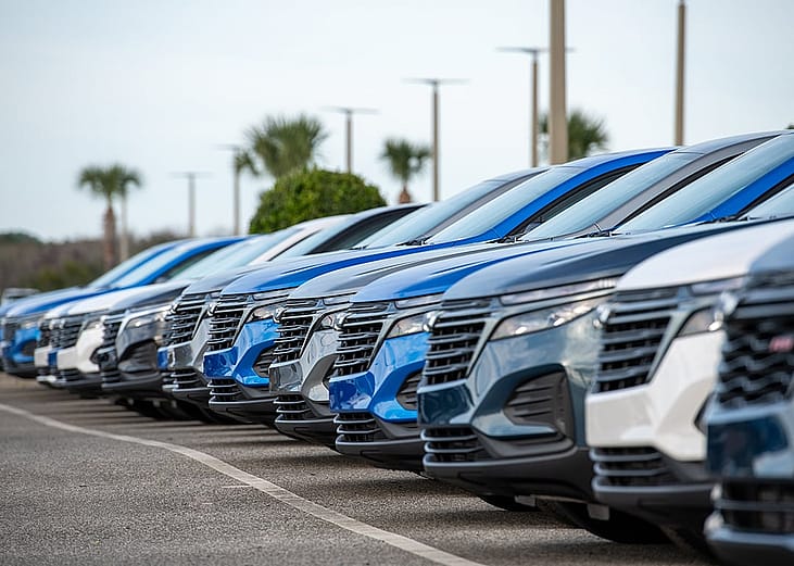 A row of Chevrolet Bolt EUV utility vehicles on a car dealership's parking lot.