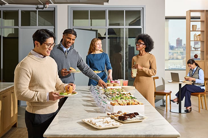 Office workers enjoying a catered lunch