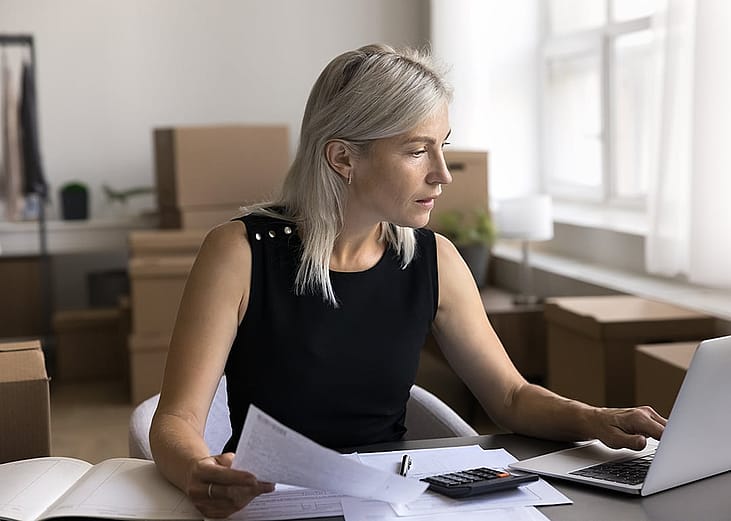 A female business owner reviewing documents in her office.