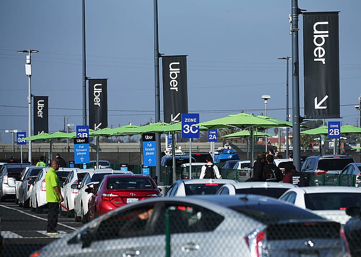 Uber vehicles lined up at the new 'LAX-it' ride-hail passenger pickup lot at Los Angeles International Airport (LAX), California.