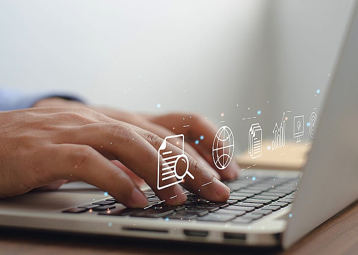 Content marketing graphics over hands typing on a laptop keyboard.