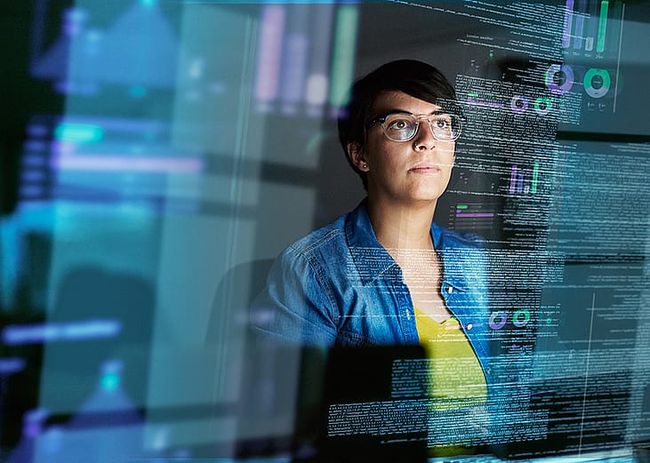 A young female computer programmer looking through data.