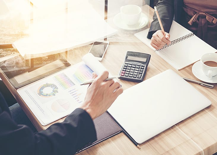 Business partners review financial documents.