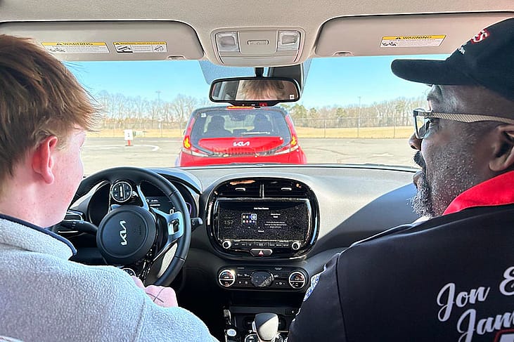 View from backseat of teen driver and expert behind the wheel. 