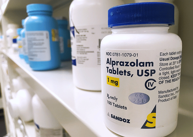 Xanax bottle on shelf.