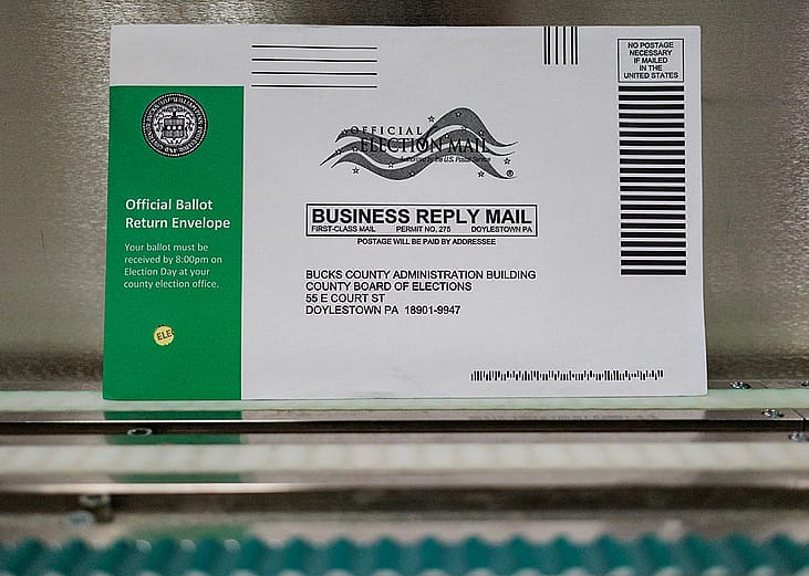 A Pennsylvania mail-in ballot with a green stripe on the envelope is displayed during a processing demonstration at the Board of Elections office on September 30, 2024 in Doylestown, Pennsylvania. 