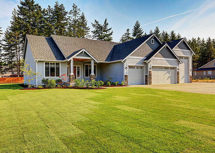 A modern, luxury home with a wide lawn in a Northwestern residential neighborhood in the US.