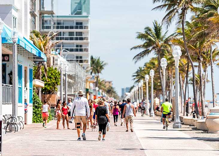 People along the beach boardwalk in Miami, Florida.