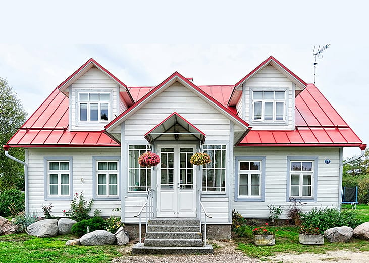 A large residential home with white and red exterior.