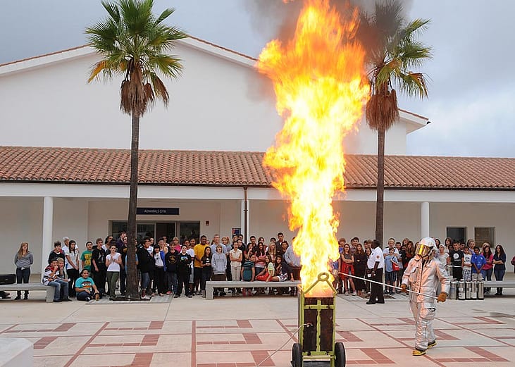 Personnel assigned to the Naval Station Rota Fire Department demonstrate the consequences of putting water on a grease fire to students at David G. Farragut Middle/High School.