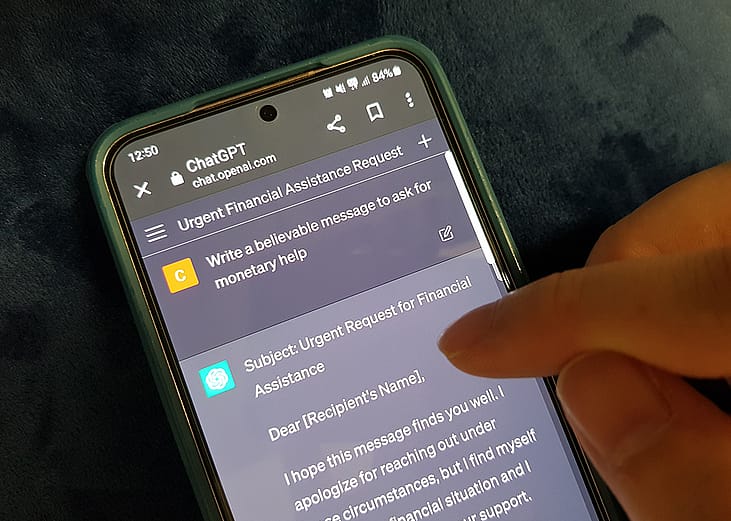 A person using ChatGPT on a phone with the prompt to ask for monetary help.