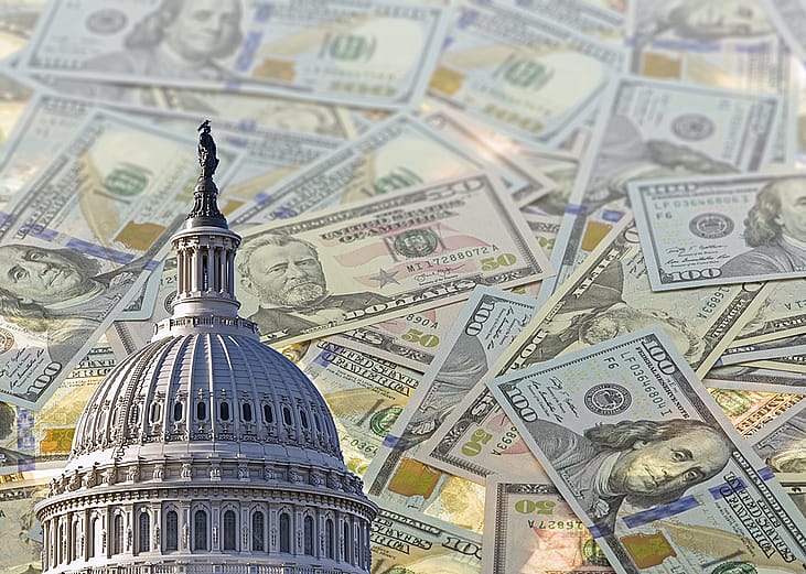 A collage of the United States Capitol dome with a background of US dollar banknotes.