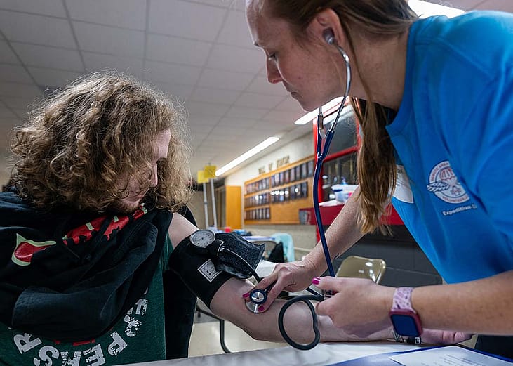 A high school student getting his blood pressure checked at a mobile medical clinic in Terre Haute South High School, Indiana.