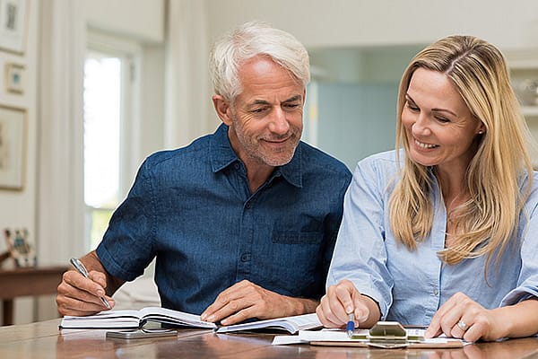 A man and a woman looking at financial documents.