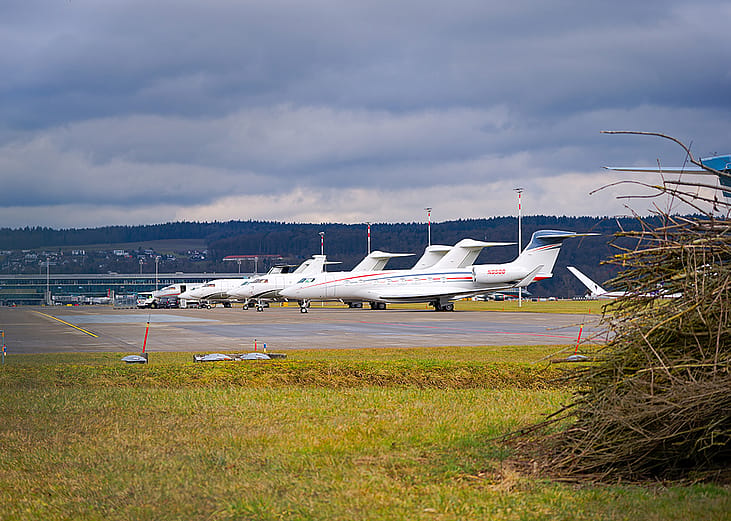Private jets parked at a Swiss airport.