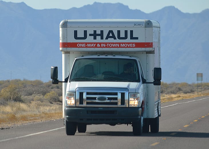 A U-Haul truck on a highway.
