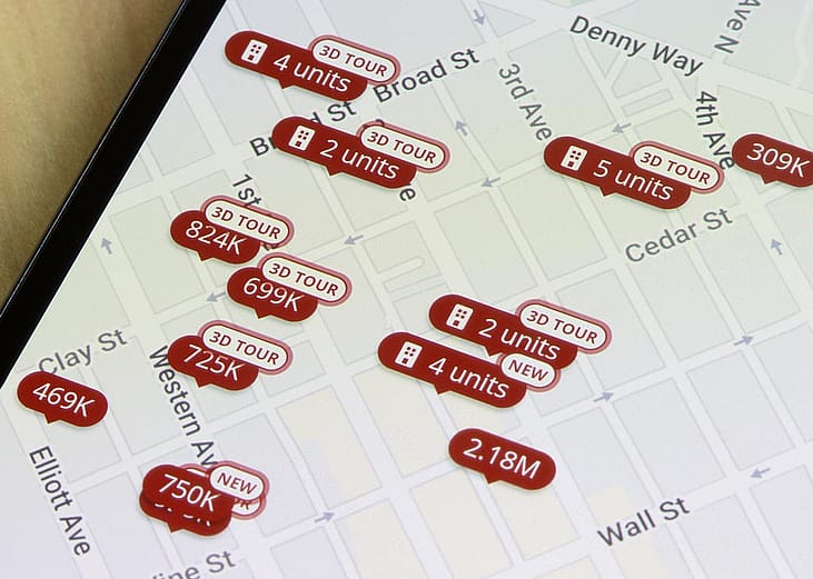 Homes listed for sale in Seattle, Washington, are seen on the map in the Zillow app on a smartphone.