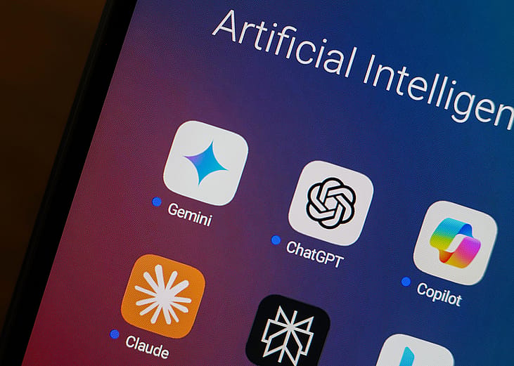 Google Gemini, ChatGPT, Microsoft Copilot, Claude by Anthropic, Perplexity and Bing apps displayed in an app folder on a smartphone.