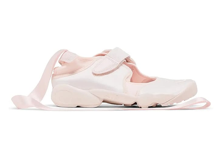 A side view of a Nike Air Rift ballerina shoe in light pink colorway.