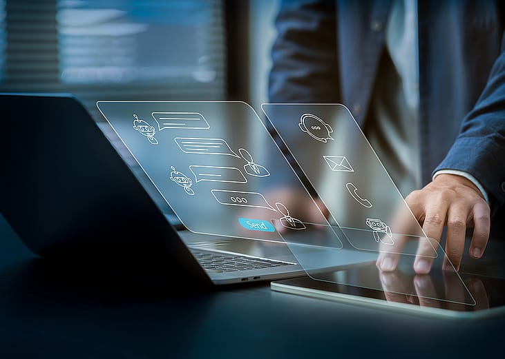 Businessman using laptop illustrated with AI software technology graphics.