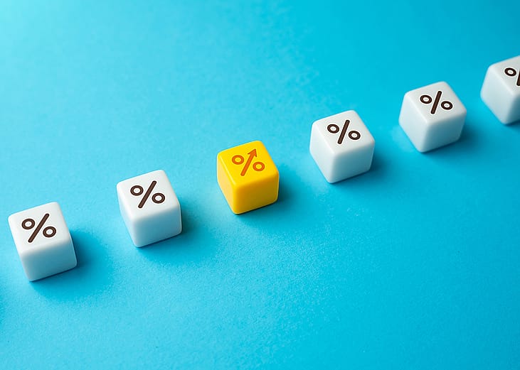 Interest rate represented by dice with percentage symbols.