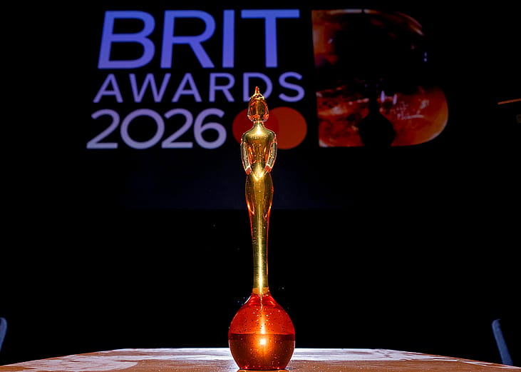 A close up on a BRIT award trophy against a background for the 'BRIT Awards 2026'.