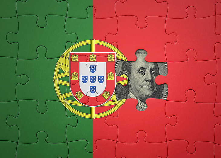 Flag of Portugal in puzzle pieces revealing a US dollar banknote.