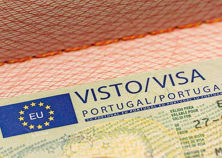 A Portuguese visa vignette on a passport with the European Union symbol.