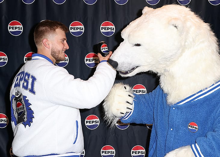 American Professional footballer Tyler Shough with Pepsi and the cola-loving polar bear during Super Bowl LX in San Francisco, California.