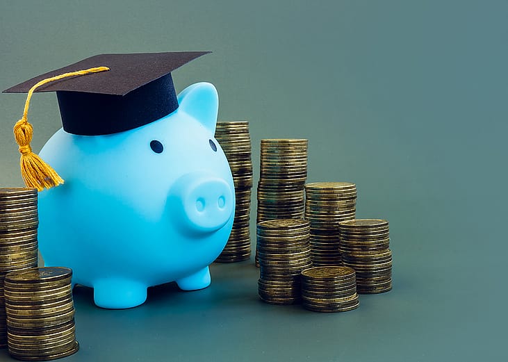 A piggy bank with a graduation cap as a concept of saving for studies.