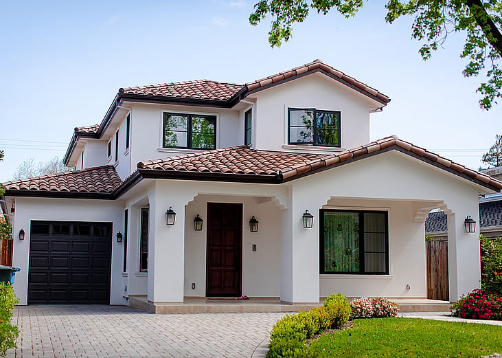 An American suburban residential house and a garage with landscaping.