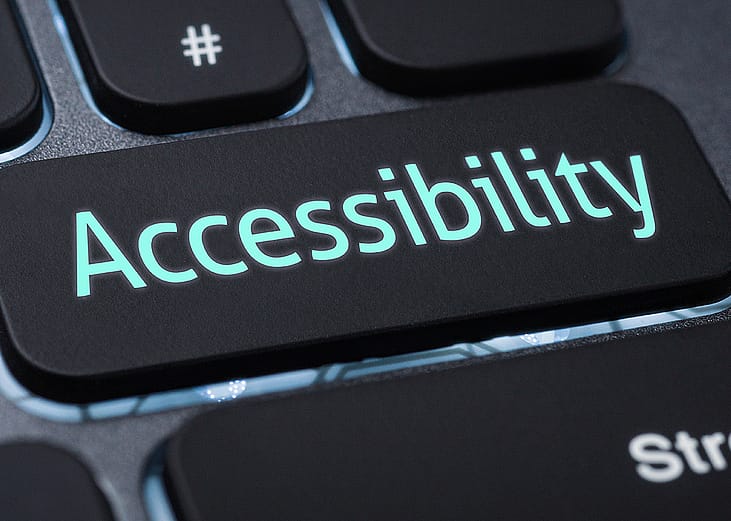 An illuminated keyboard cap labeled with Accessibility. 