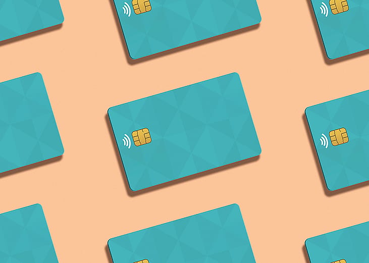 Teal credit cards against a peach background.
