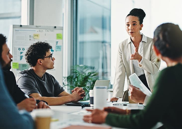 A businesswoman leading a marketing team's meeting.