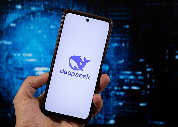 A person checking a DeepSeek AI app from a smartphone.