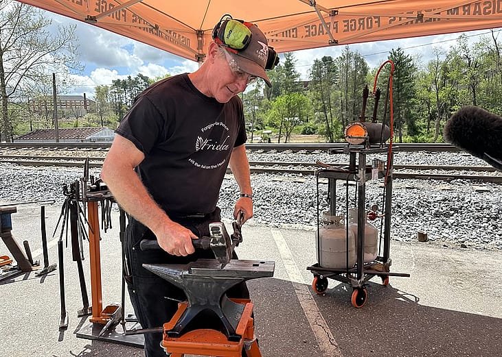 Scotty Utz, RAWtools South’s blacksmith, leads a demonstration at the 2025 Fire on the Mountain Festival in Spruce Pine, North Carolina.