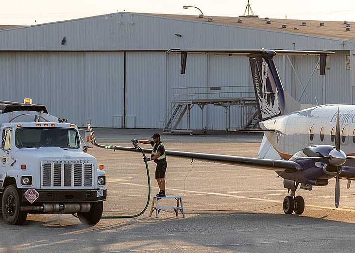 Aircraft staff refuels a private plane.