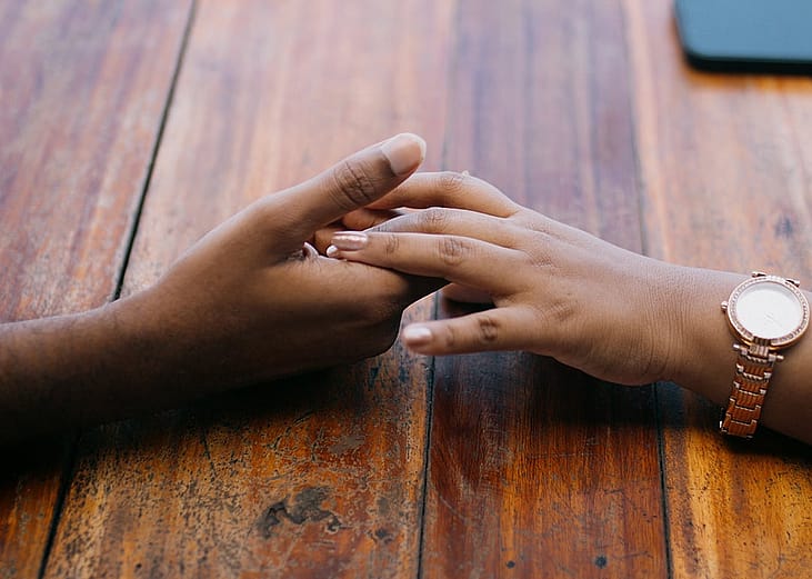 Two hands holding each other.