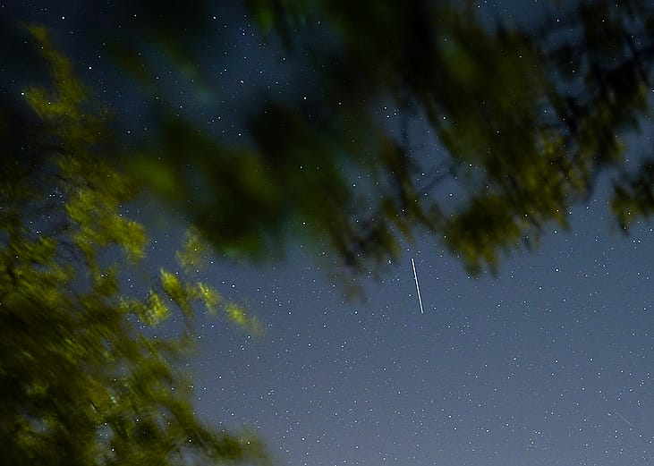A satellite from a larger group of satellites called Starlink seen trailing across the night sky.