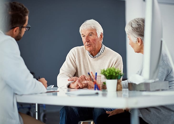 A senior couple consulting with a doctor for a health checkup. 