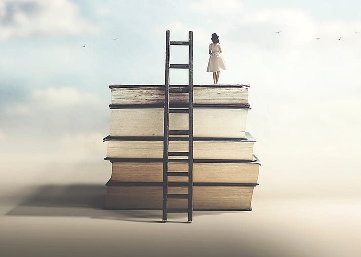 A girl on top of a pile of books with ladder as a concept of achieving education and wisdom.