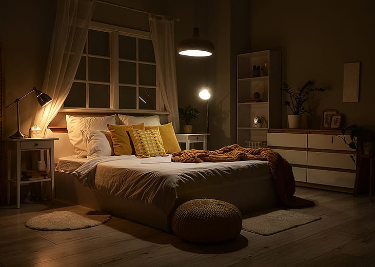 Interior of a modern bedroom with ambient lamps and lighting.