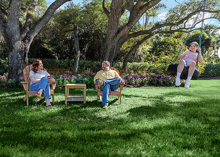 A family enjoying their time in the house yard.
