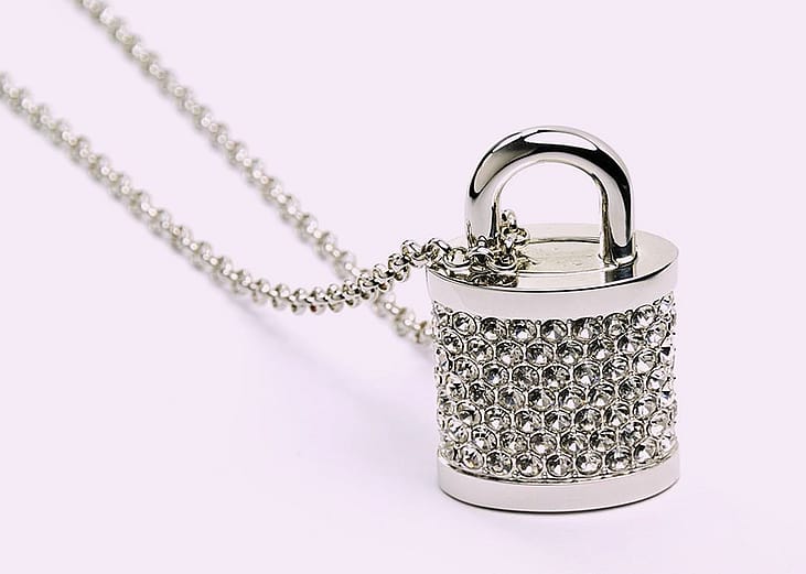 A bejeweled padlock with a string.